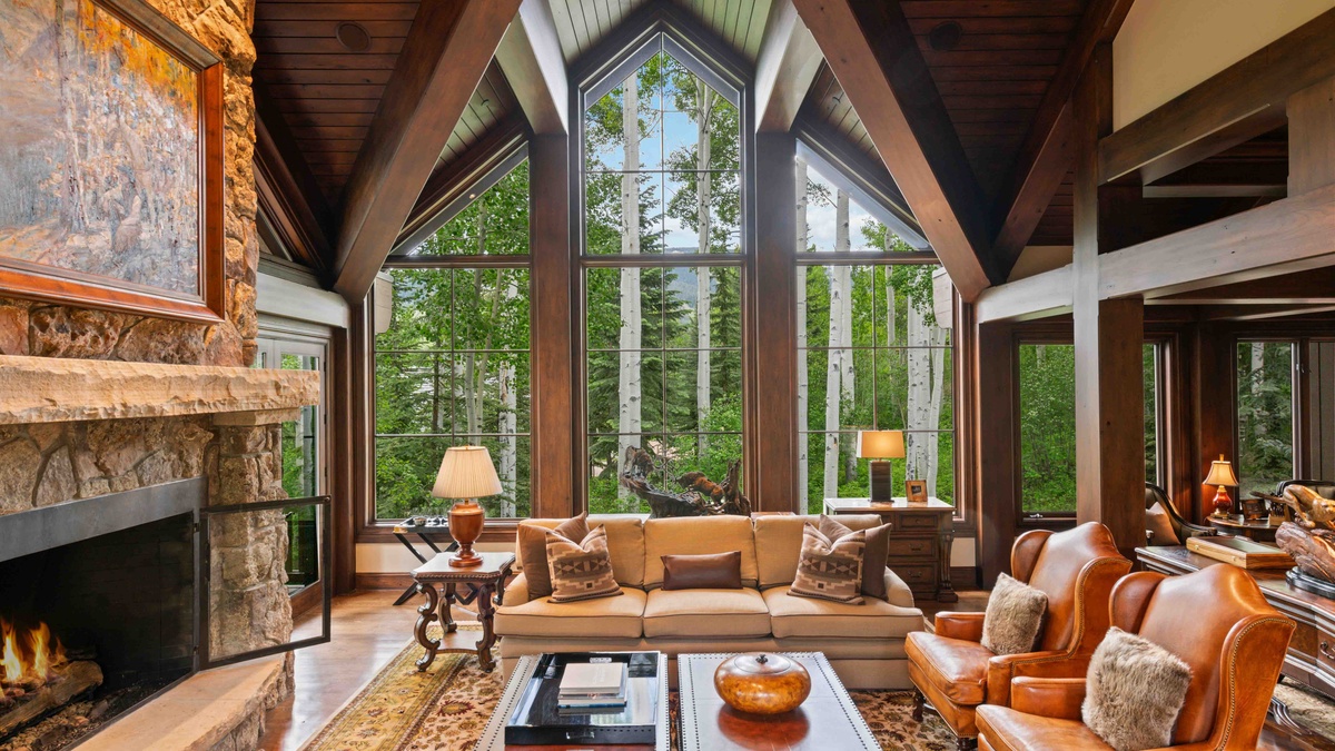 Floor-to-celing vaulted windows beckon the outdoors in