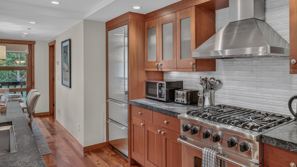 Kitchen, Main Level - Range and microwave with surrounding cabinetry