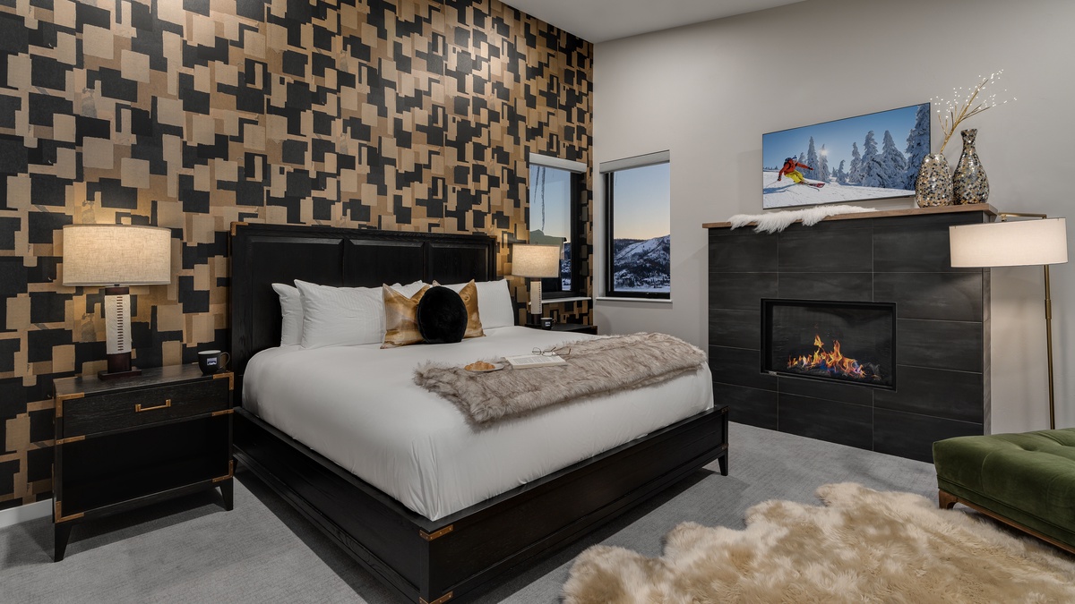 Primary king suite on main level with fireplace and TV