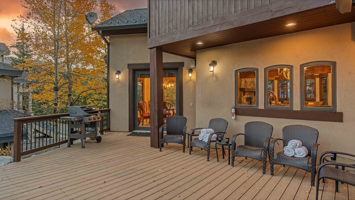 Back patio with grill, seating, and hot tub
