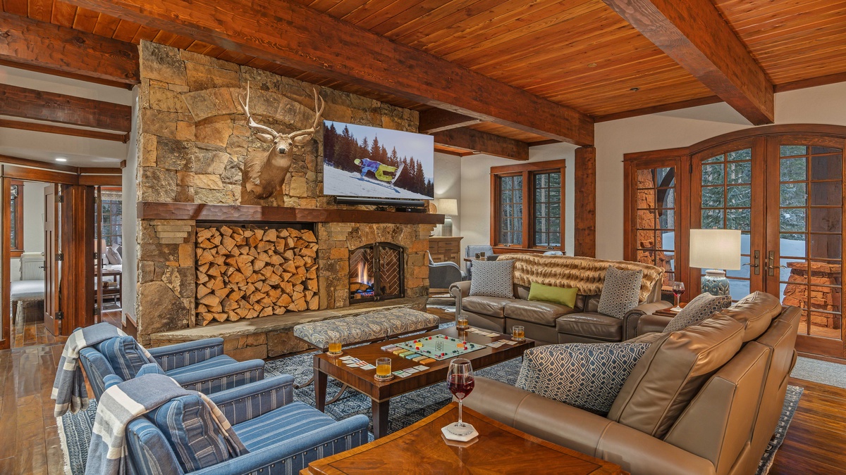 Lower level family room with fireplace, TV, and hot tub patio access