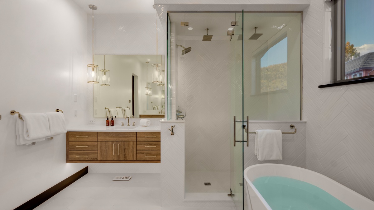 Bedroom 1, Main Level - Primary ensuite with separate vanities and 3-head shower