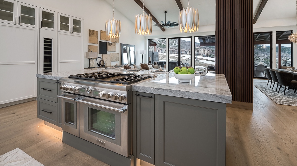 Kitchen, Upper Level - With gas range, marble countertops, and pendant lighting