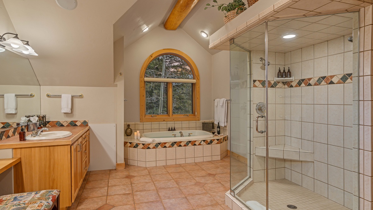 Bedroom 1, Upper Level - Primary ensuite with dual vanities, tub, and large walk-in shower