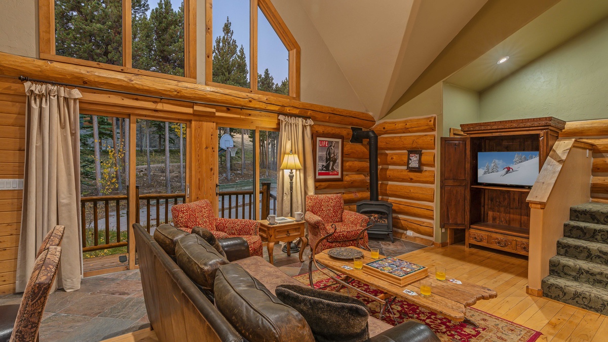 Upper Level - Family room with fireplace with access to basketball court