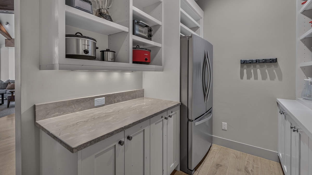 Kitchen, Upper Level - Countertop with open shelving and refrigerator