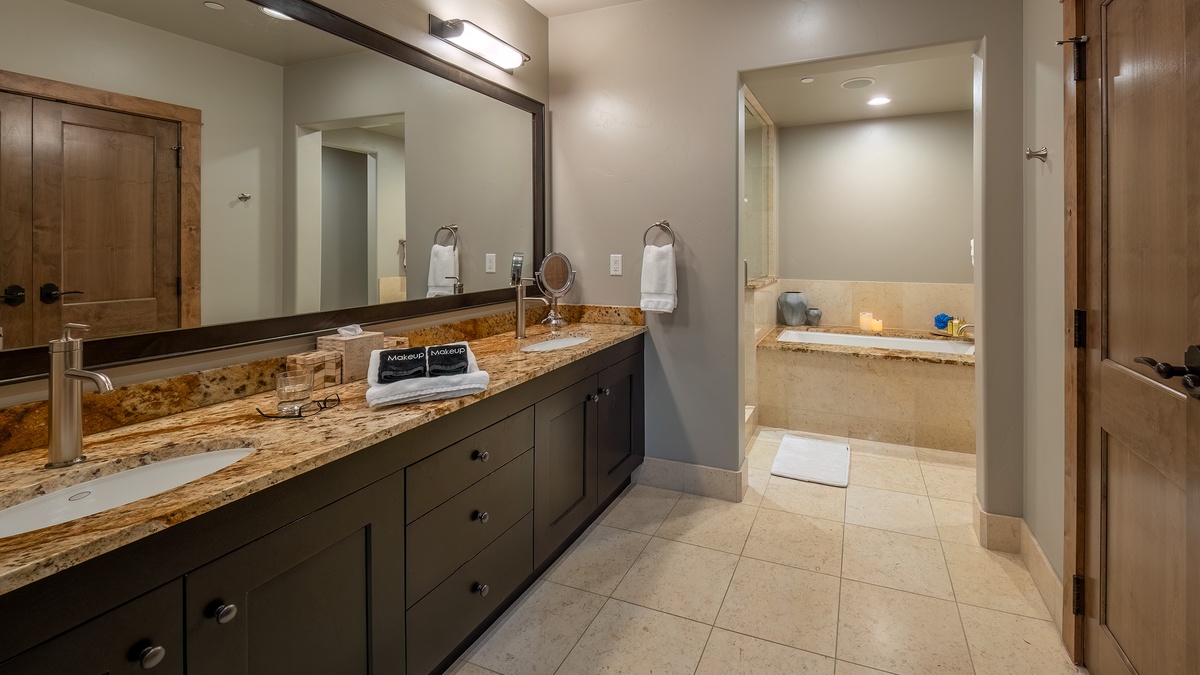 Bedroom 1, Main Level - Primary king ensuite with spacious vanity and soaking tub