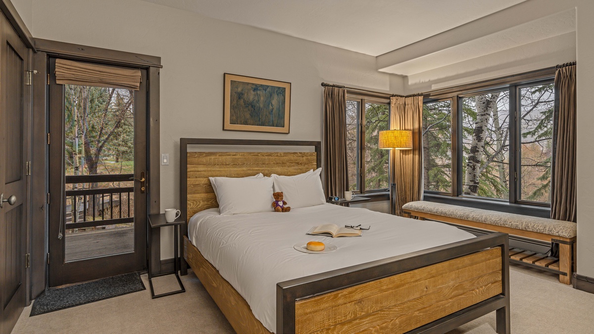 Bedroom 5, Lower Level - Full bedroom with private balcony, TV, and shared bath on the guest apartment (3rd) level