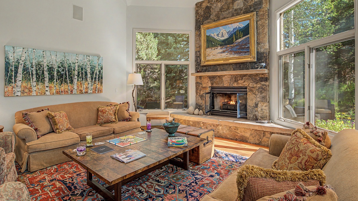 Great Room, Main Level - Fireplace with seating area beside large windows
