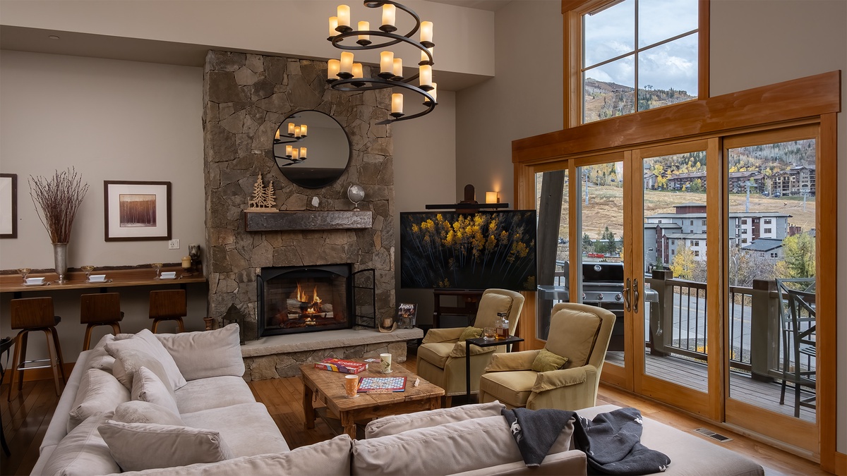 Great Room, Main Level, Sunshine Peak Chalet - Seating area with fireplace and deck access