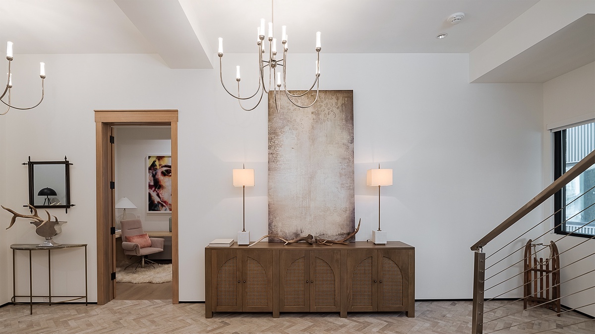 Entryway, Main Level - Cabinet with table lamps and wall art along family room