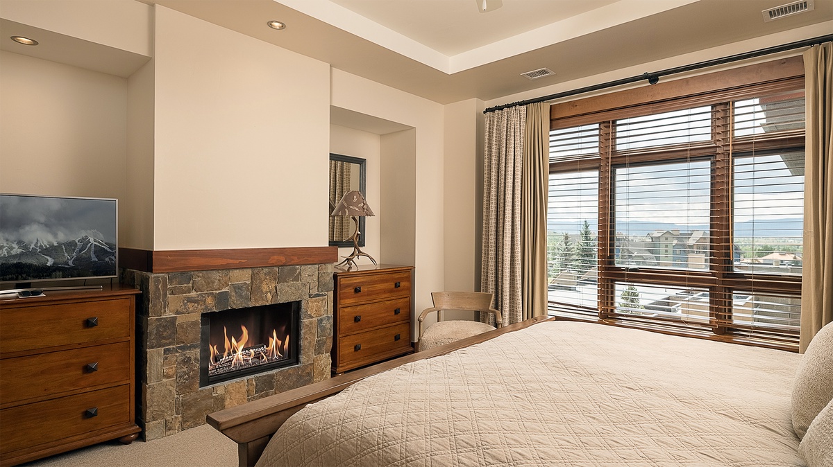 Bedroom 1, Main Level - Primary king bedroom with fireplace and mountain views