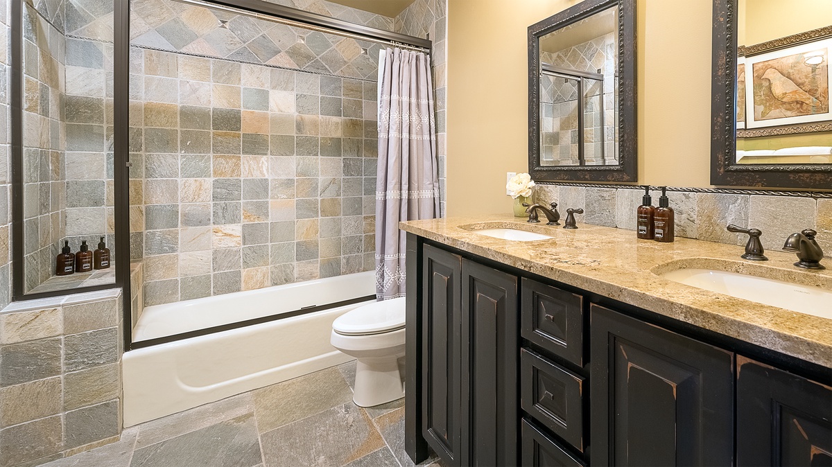 Sink into relaxation in your elegant bathroom, where natural stone tiles and a deep soaking tub create a serene spa-like retreat.