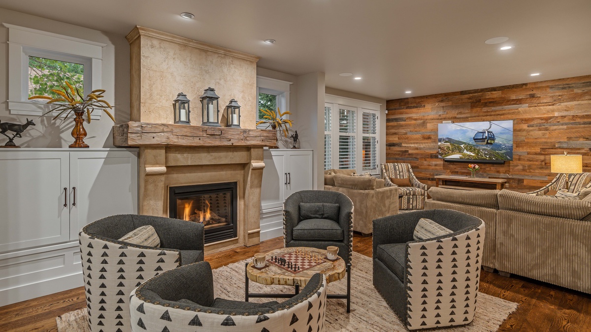 Main level great room with fireplace and TV