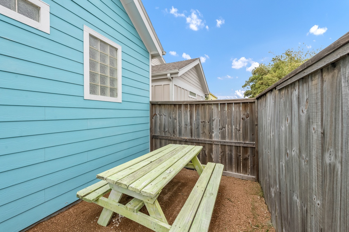 Your private outdoor dining space awaits with a charming picnic table perfect for morning coffee or evening meals under the open sky.