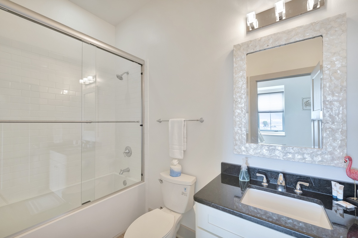 Unwind in your elegant bathroom with sparkling marble accents, rainfall shower, and modern fixtures designed for your comfort.