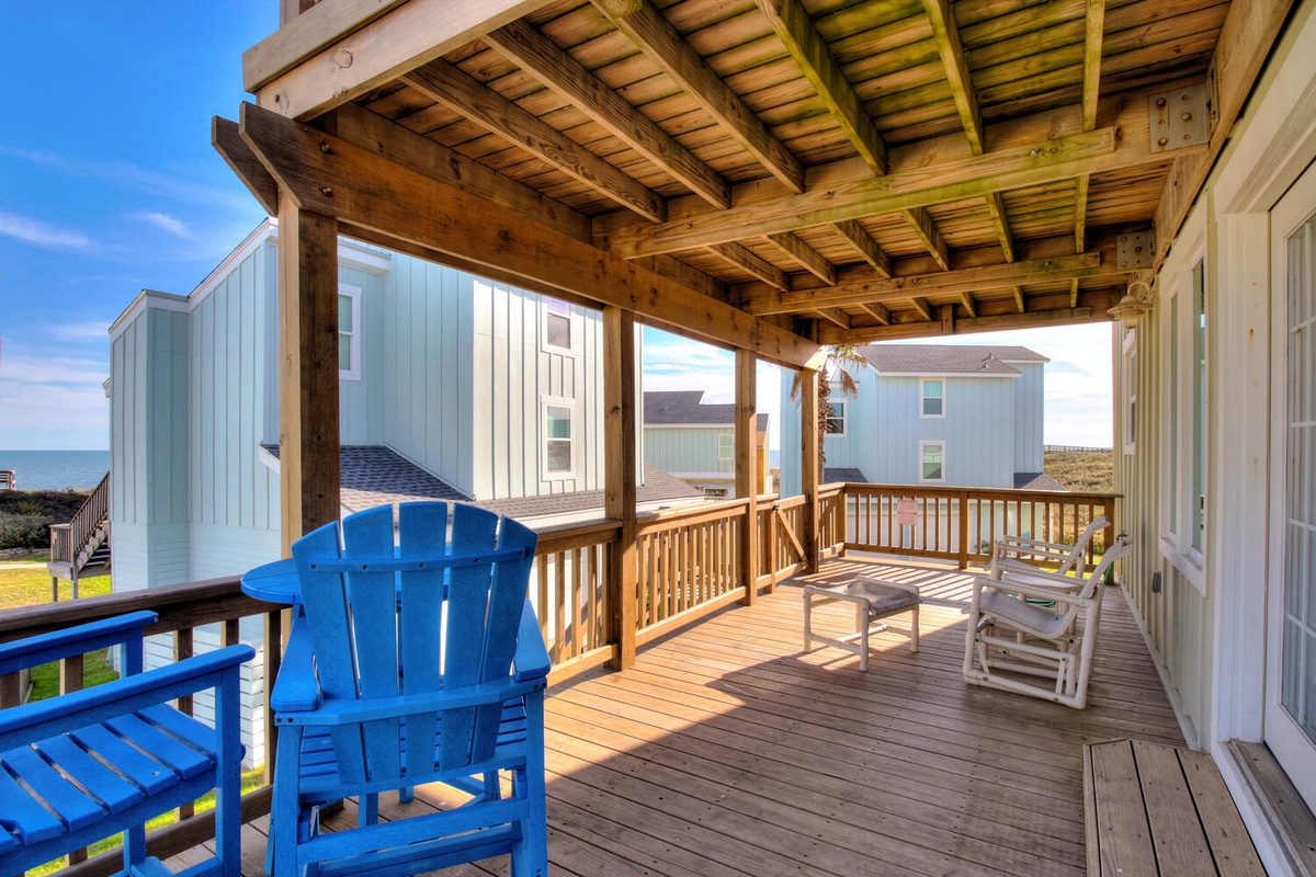 Relax on your private covered deck with ocean glimpses, where coastal breezes and comfortable seating create the perfect retreat.