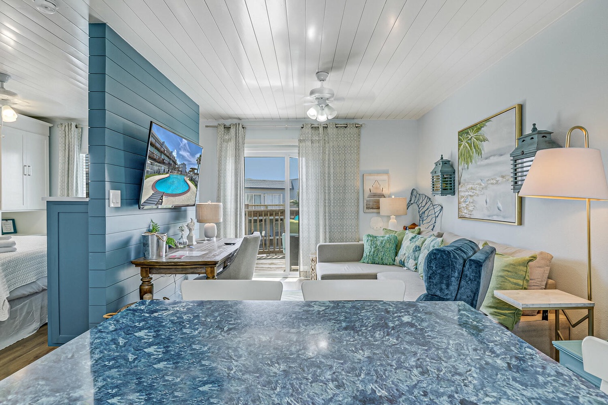 Your coastal retreat features soothing blue tones, a marble island, and sliding doors to your private balcony.