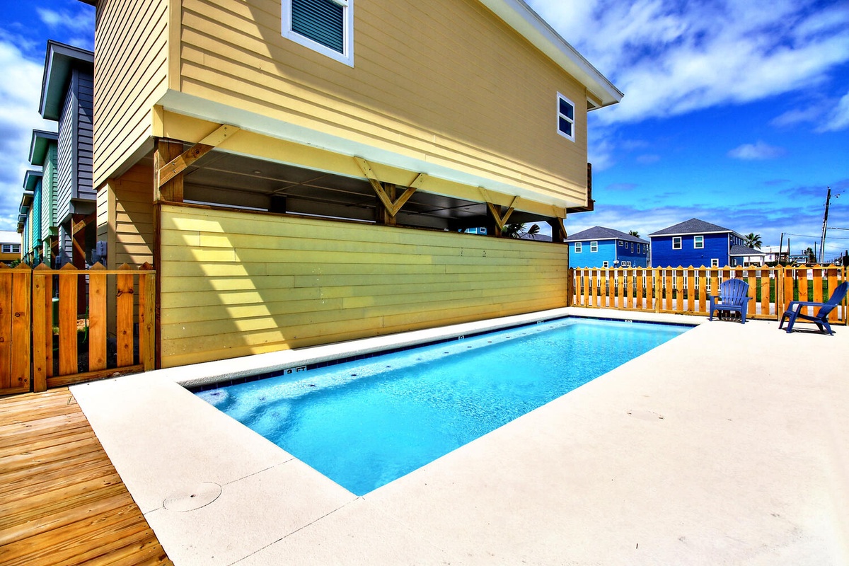 Your private pool awaits beneath the covered patio, perfect for cooling off after sunny beach days.