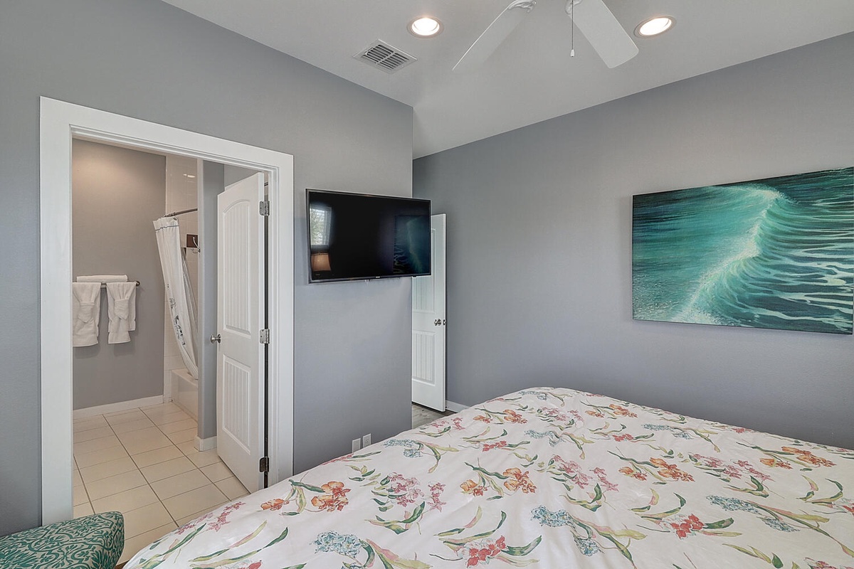 Relax in your serene bedroom with ocean-inspired artwork and wall-mounted TV, while your private en-suite bathroom awaits just steps away.