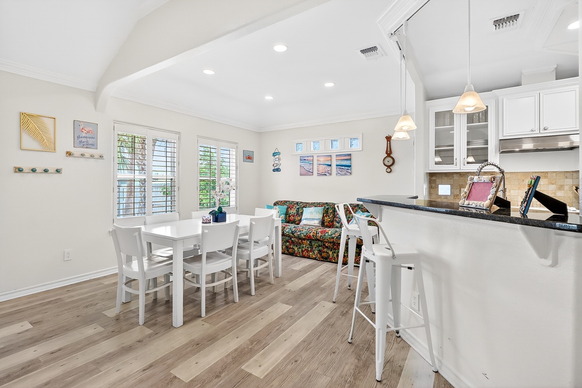 You'll love gathering in this bright, open kitchen and dining space with modern appliances and charming coastal touches.