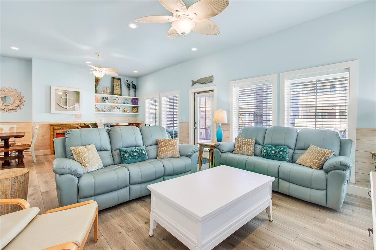 Sink into coastal comfort in this bright living room, where soft sea-foam sofas and beach-themed decor create your perfect seaside retreat.