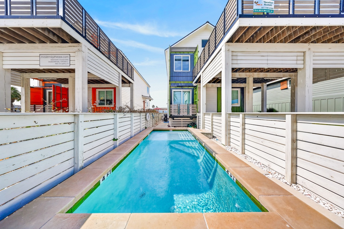 This private lap pool is your personal oasis, tucked between modern beach-style architecture with direct access from your rental. Cool off after sunny beach days in this serene space.