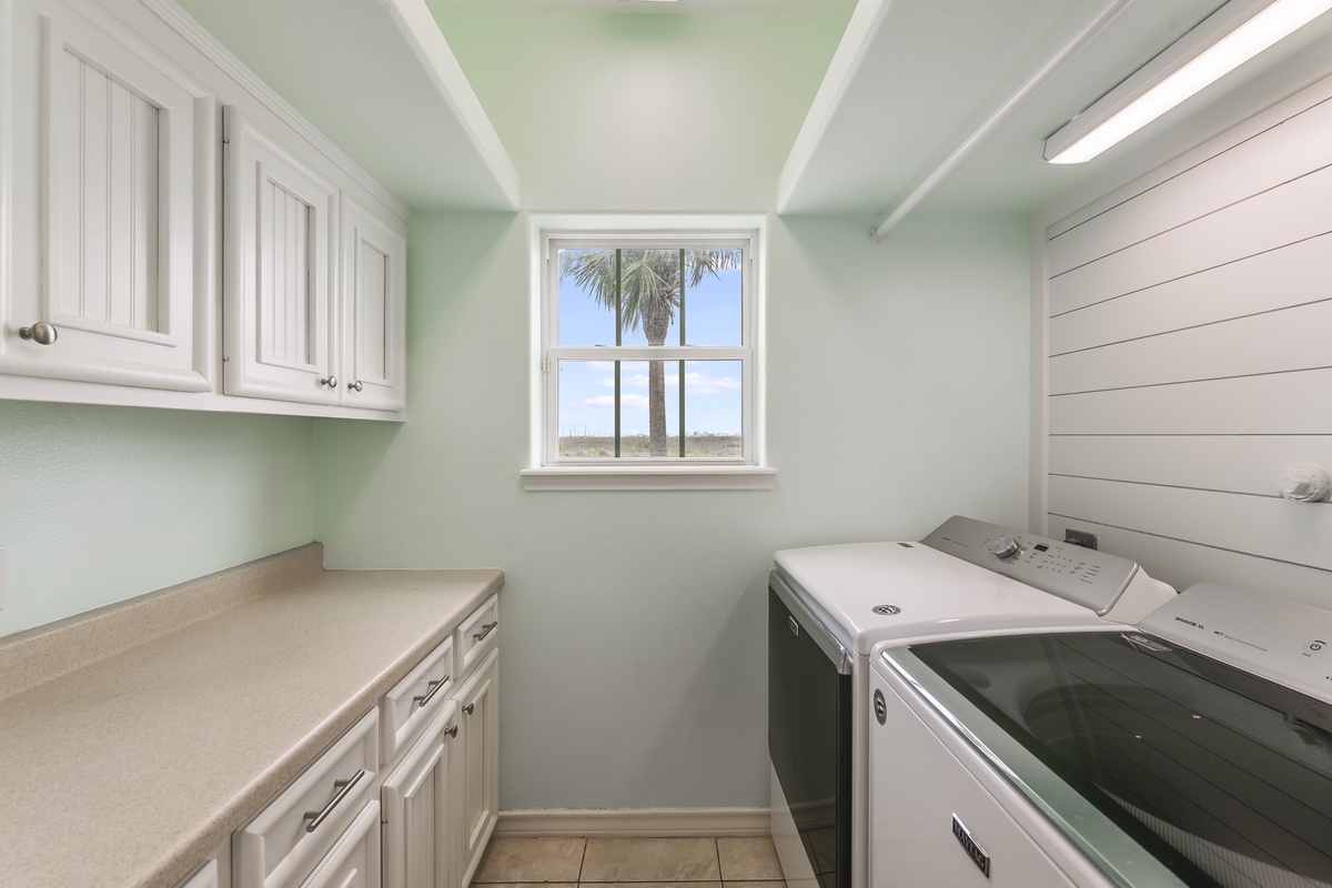 Your dedicated laundry room features modern appliances and ample storage, with tropical views to make chores feel like a breeze.