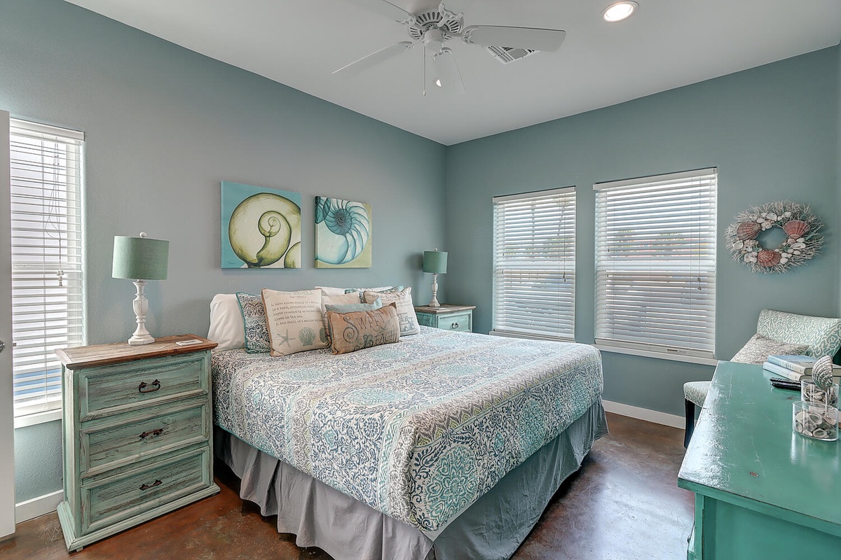 Drift away in this tranquil bedroom where soothing sea-glass walls and coastal artwork create your perfect seaside sanctuary.