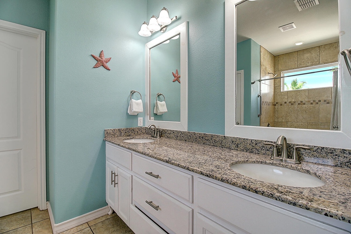 Your spacious bathroom features granite countertops, dual sinks, and coastal charm with starfish accents welcoming you to unwind.