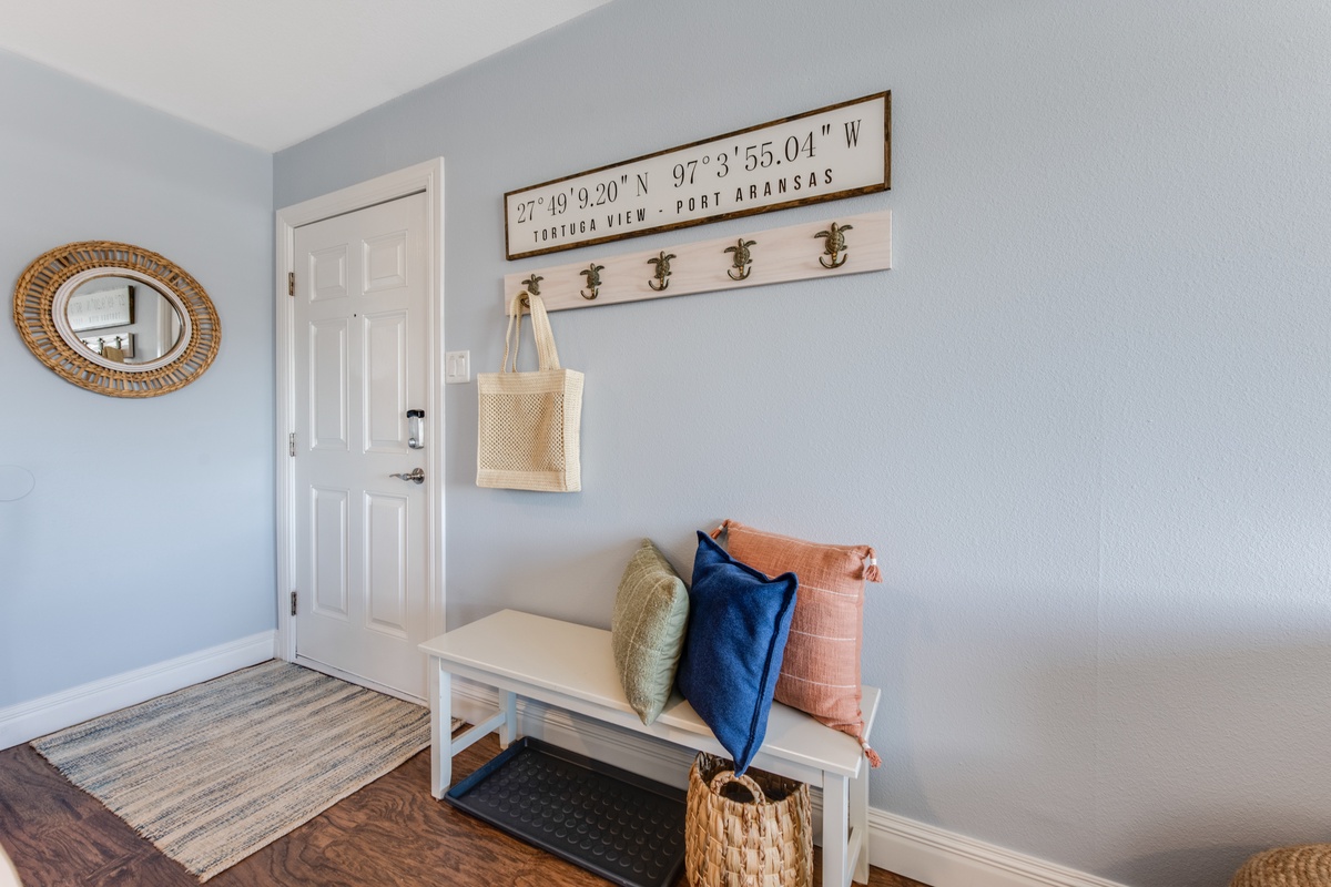Your warm welcome begins at this charming entryway, where coastal touches and thoughtful hooks create the perfect spot to settle in.