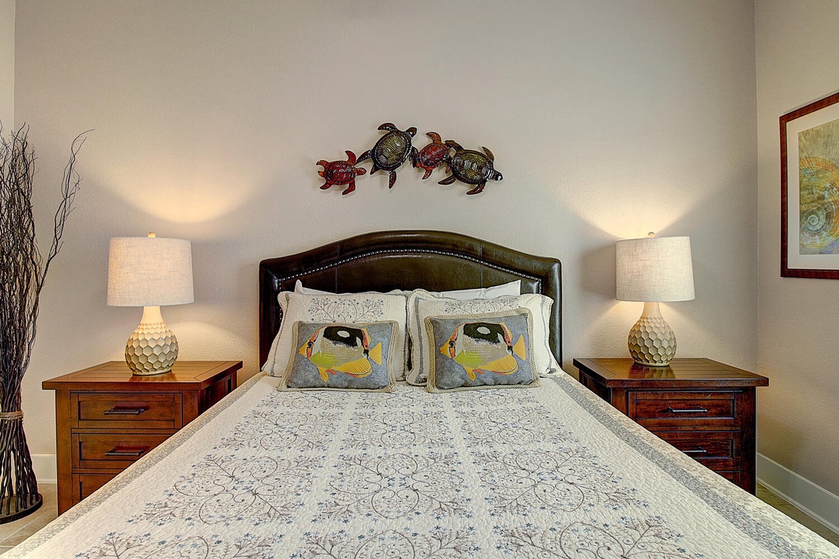 Drift off to dreamland in your cozy bedroom featuring a plush queen bed, whimsical turtle decor, and warm bedside lighting.