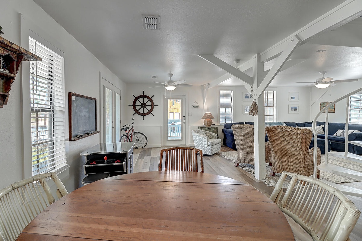 Gather around this spacious dining table where your coastal retreat comes to life, surrounded by nautical charm and open-concept comfort.