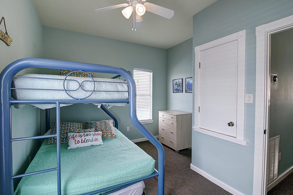 Settle into this cozy bunk room where turquoise walls and cheerful bedding create the perfect space for your family adventure.