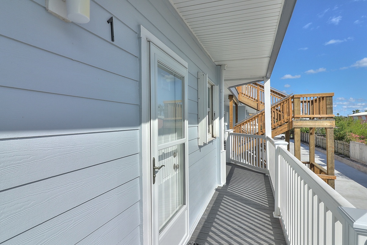 Step onto your private covered balcony with crisp white railings and enjoy the fresh air from your elevated retreat.