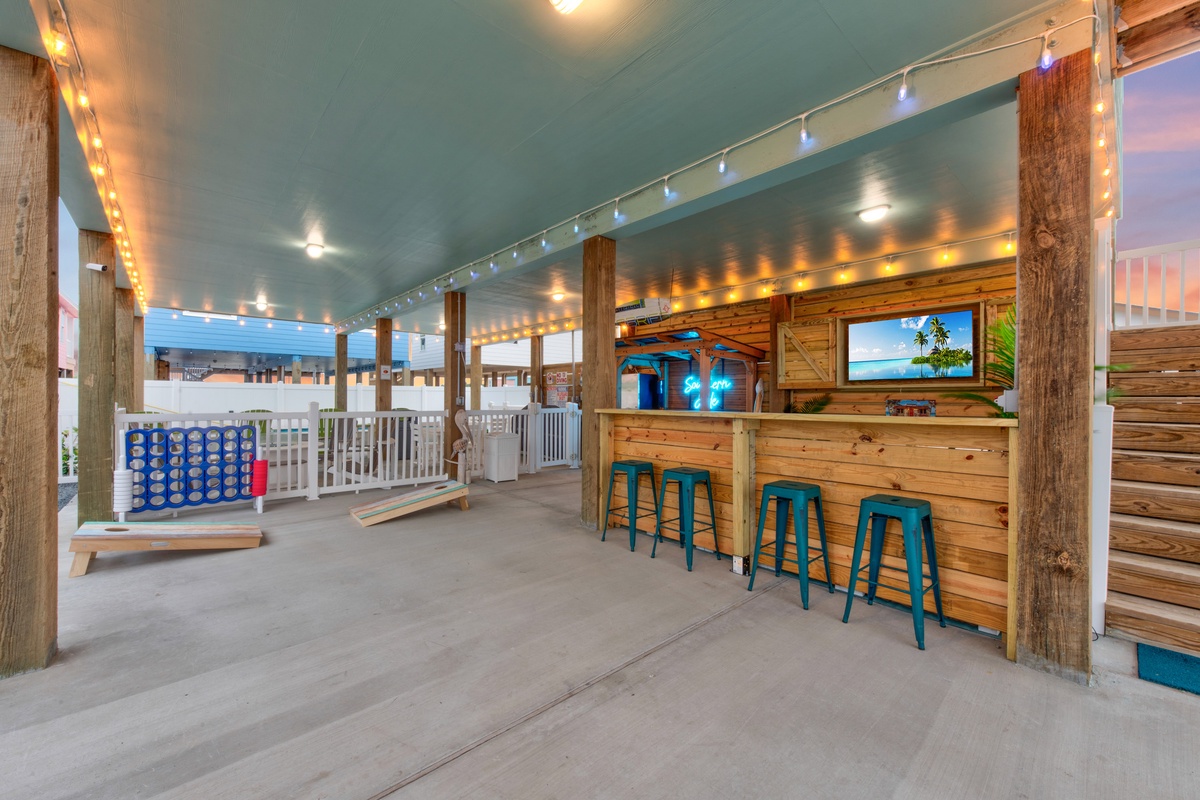 Your private outdoor bar awaits with twinkling lights, tropical vibes, and giant Connect Four for endless entertainment under the covered patio.