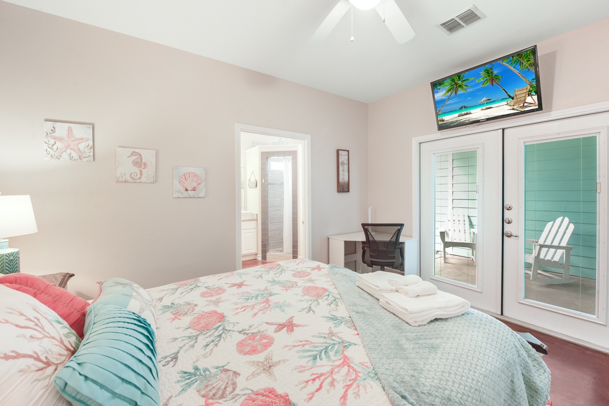 Drift off in your coastal-themed bedroom with soft tropical linens, beachy artwork, and French doors opening to your private balcony retreat.