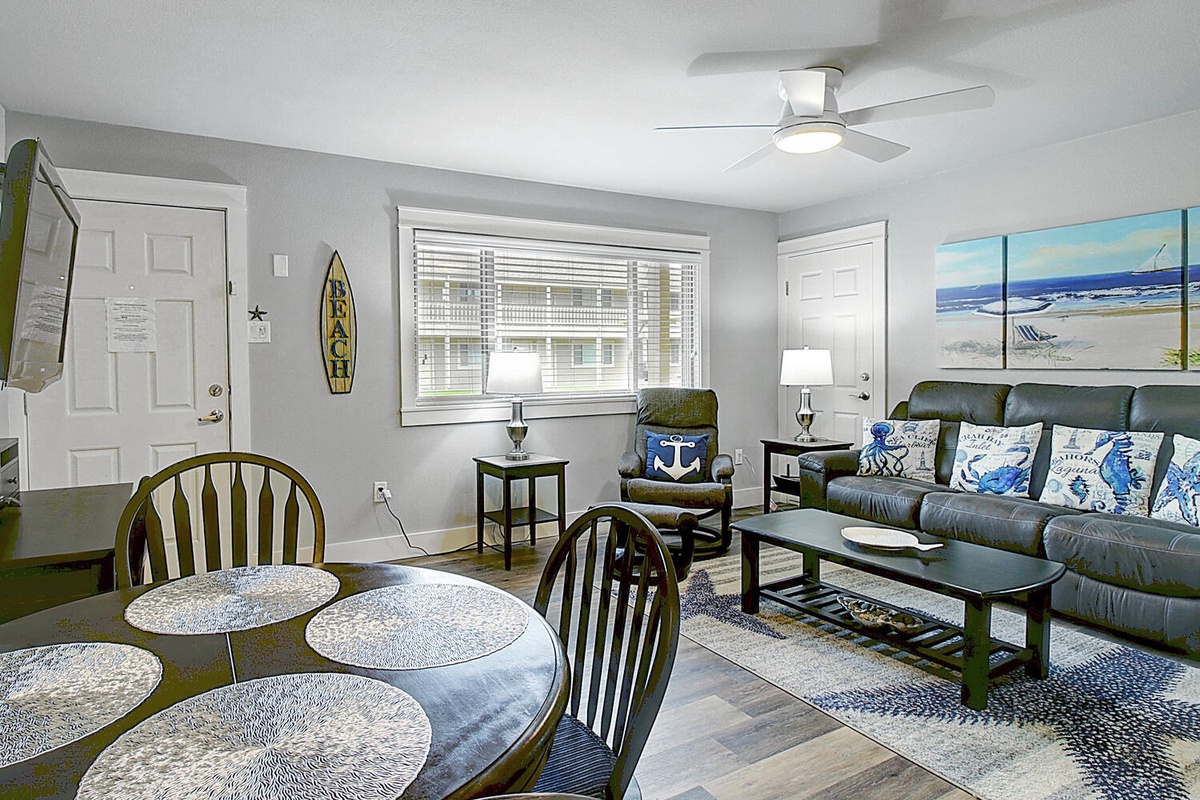 Sink into coastal comfort in your spacious living area, where ocean-themed décor and leather seating create the perfect beach house retreat.