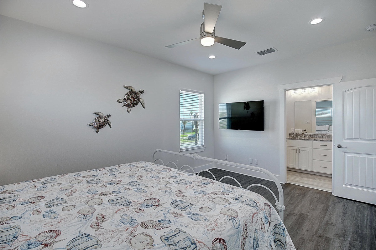 Rest peacefully in your coastal bedroom with charming turtle artwork and ceiling fan for gentle breezes on warm nights.