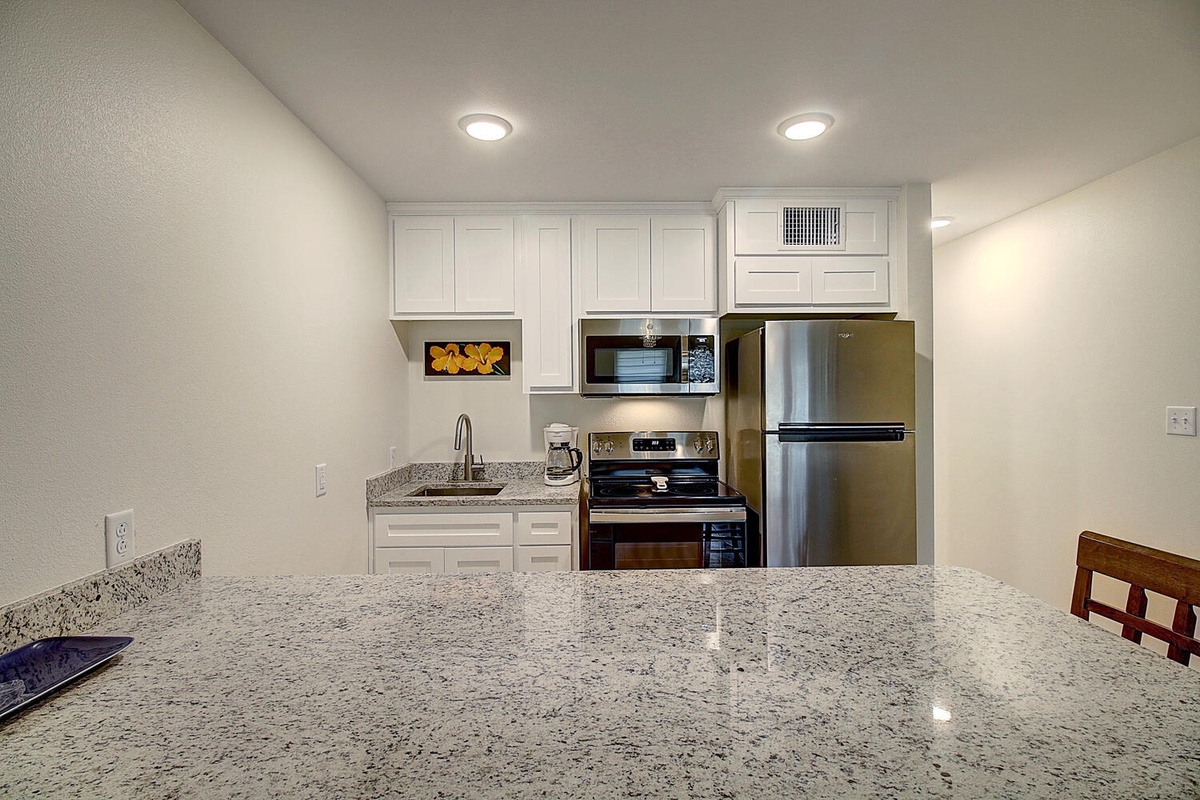 Your fully equipped kitchen features granite countertops, stainless steel appliances, and everything needed to prepare meals during your stay.