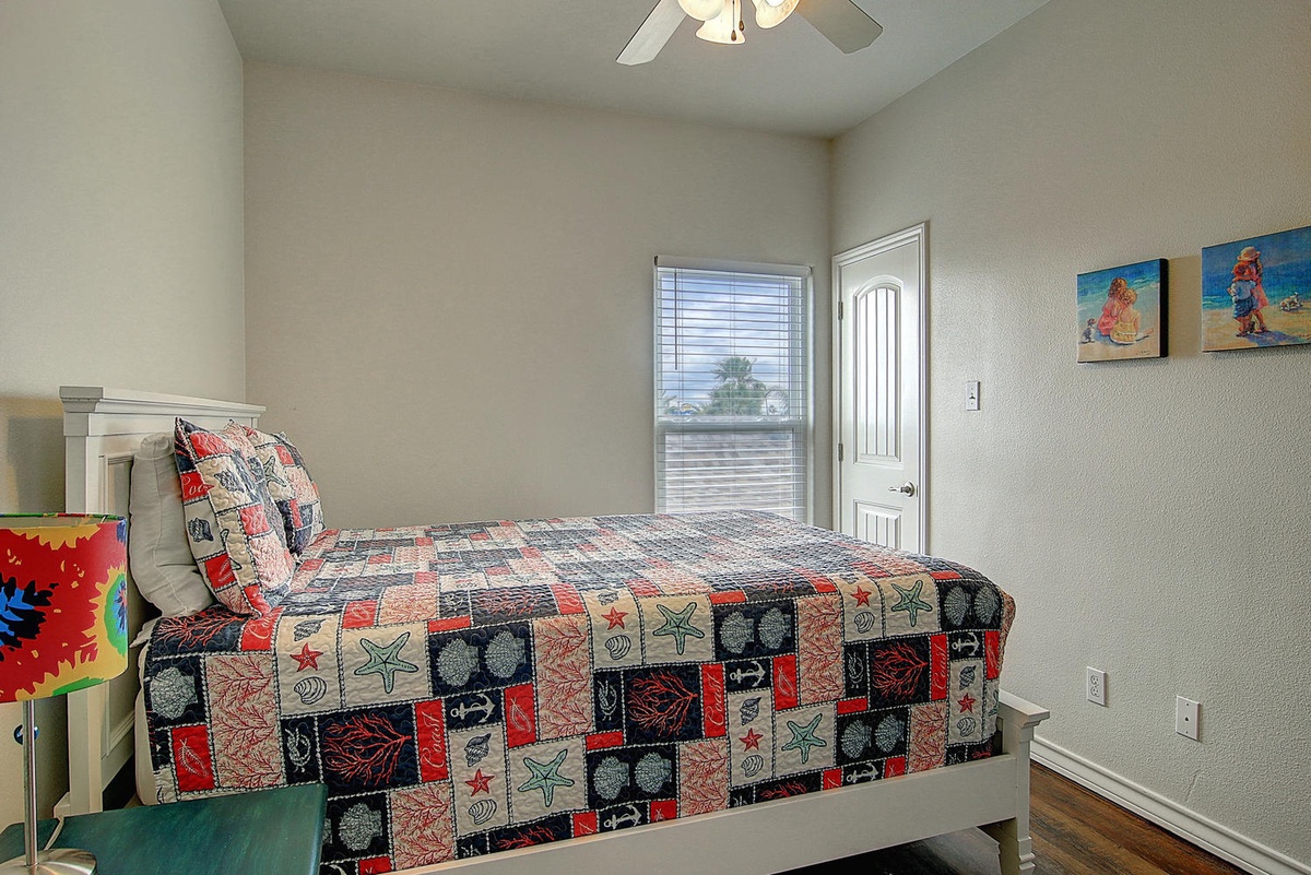 Your kids will love this cheerful bedroom with its fun quilt and beach-themed artwork creating the perfect space for sweet dreams.