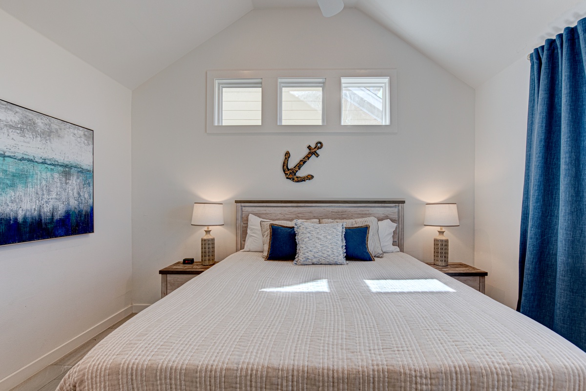 Drift off in your serene bedroom sanctuary, where coastal blues and warm lighting create the perfect atmosphere for restful nights.