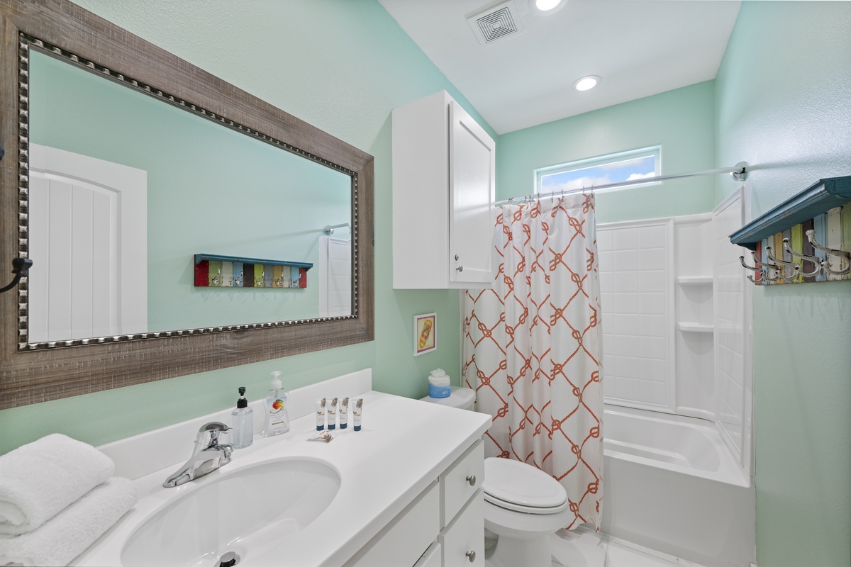 Refresh in your bright, coastal-inspired bathroom with soft mint walls, a large vanity, and a roomy shower-tub combo. Plush towels and thoughtful touches make it feel like your own personal spa.
