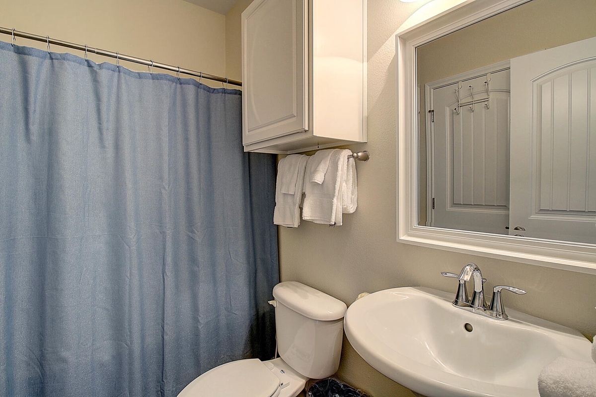 Your private bathroom features fresh towels, a spacious shower, and thoughtful storage to make your stay comfortable.