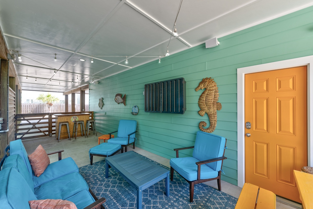 Relax in your own coastal retreat with cheerful turquoise seating, playful seaside décor, and easy access to a sunny outdoor bar—perfect for unwinding after beach adventures.