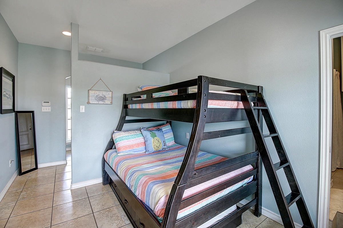 Cozy bunk room with colorful striped bedding creates a fun, family-friendly space for your group's adventures.