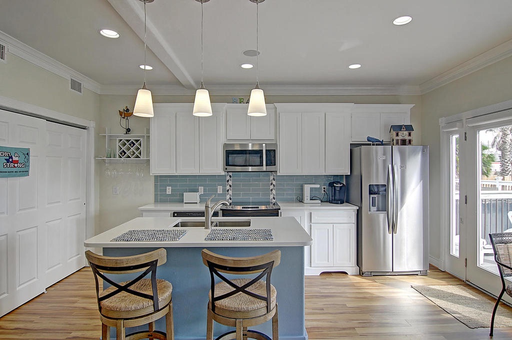 Your bright, coastal-inspired kitchen awaits with modern appliances, granite counters, and a breakfast bar perfect for morning coffee.