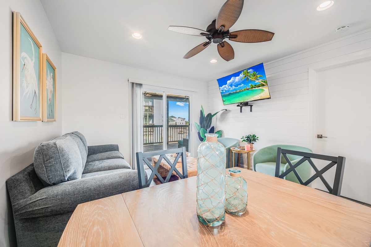 Relax in your bright living space with tropical touches, ceiling fan, and sliding door access to your private balcony.