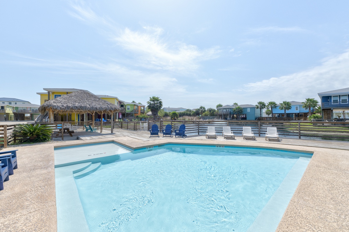 Take a refreshing dip in the crystal-clear community pool, surrounded by swaying palms and colorful waterfront homes along the peaceful canal.
