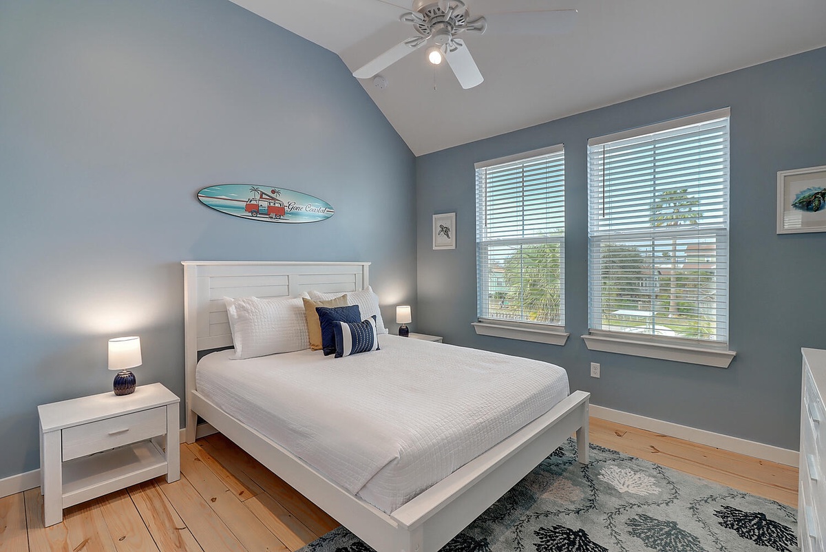 Your peaceful retreat features calming blue walls and crisp white bedding for restful nights after beach adventures.